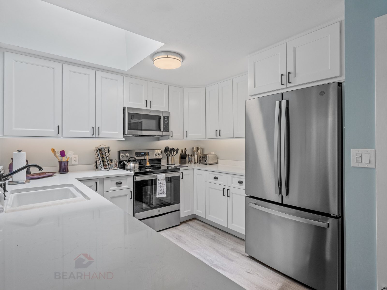 Custom kitchen island with quartz countertop by BearHand Construction